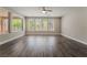 Bright and airy living room featuring hardwood floors and large windows offering backyard views at 133 Clouded Ave, Henderson, NV 89002