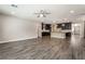 Bright living room with wood-look floors flowing into a modern kitchen and dining area at 133 Clouded Ave, Henderson, NV 89002