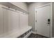 Mudroom with a built-in bench with hooks and shoe storage, adjacent to the entry door at 133 Clouded Ave, Henderson, NV 89002