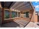 Covered outdoor patio area with wood-slat roof providing shade for entertaining at 133 Clouded Ave, Henderson, NV 89002
