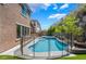 Backyard pool area with -safe fencing, lush landscaping, and an in-ground hot tub at 133 Clouded Ave, Henderson, NV 89002