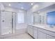 Bright bathroom features a double sink vanity, and a glass enclosed shower and bath at 145 Aqua Commons Ln, Henderson, NV 89015