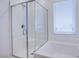 Beautiful bathroom featuring glass enclosed shower and separate tub beneath the window at 145 Aqua Commons Ln, Henderson, NV 89015