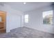 Bedroom showcasing ample natural light, plush carpet, and a double-door closet at 145 Aqua Commons Ln, Henderson, NV 89015