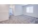 Spacious bedroom featuring neutral carpet and a large window providing natural light at 145 Aqua Commons Ln, Henderson, NV 89015