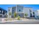 Modern multi-story exterior with gray facade, complemented by desert landscaping at 145 Aqua Commons Ln, Henderson, NV 89015