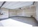 Large empty two car garage with door leading to the interior of the home at 145 Aqua Commons Ln, Henderson, NV 89015