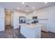 Bright kitchen features stainless steel appliances, an island, and plenty of white cabinets at 145 Aqua Commons Ln, Henderson, NV 89015