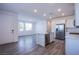 Open-concept kitchen with stainless steel appliances, island, and direct view to the living room at 145 Aqua Commons Ln, Henderson, NV 89015