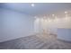 Open loft space with neutral carpet, recessed lighting, and bright white walls at 145 Aqua Commons Ln, Henderson, NV 89015