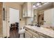 Bathroom with modern fixtures, a decorative mirror, tiled shower, and adjacent storage at 1491 Sunrise View Dr, Las Vegas, NV 89110