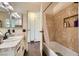 Bright bathroom featuring mosaic tile accent wall and tile surround tub and shower at 1491 Sunrise View Dr, Las Vegas, NV 89110