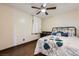 Neutral toned bedroom featuring a ceiling fan, wood floors, modern bedframe and vibrant throw pillows at 1491 Sunrise View Dr, Las Vegas, NV 89110
