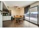 Open dining area with wood floors, modern lighting, and sliding glass doors to the backyard at 1491 Sunrise View Dr, Las Vegas, NV 89110
