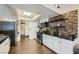 Modern kitchen featuring stainless steel appliances, stylish backsplash, and wood-look floors at 1491 Sunrise View Dr, Las Vegas, NV 89110