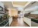 Bright kitchen area with stainless steel appliances and views into the living and dining areas at 1491 Sunrise View Dr, Las Vegas, NV 89110