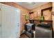Spacious laundry room with brick walls, appliances, and shelving at 1491 Sunrise View Dr, Las Vegas, NV 89110