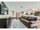 Spacious living room with wood floors, a large TV, and open access to the kitchen at 1491 Sunrise View Dr, Las Vegas, NV 89110