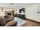 Comfortable living room with a brick fireplace, wood floors, and ample seating at 1491 Sunrise View Dr, Las Vegas, NV 89110