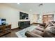 Cozy living room with a large TV, wood-look floors, and neutral decor at 1491 Sunrise View Dr, Las Vegas, NV 89110