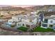 A stunning aerial view highlights the home's modern design, pool, landscaping, and desirable community setting with mountain views at 2004 Peaceful Mesa Ct, Henderson, NV 89052