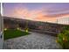 Backyard features a stone-paved area, lush landscaping, and a tranquil setting for outdoor enjoyment at 2004 Peaceful Mesa Ct, Henderson, NV 89052