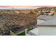 Scenic aerial view of a community with mountains and sunset, backyard with black fence and artificial grass at 2004 Peaceful Mesa Ct, Henderson, NV 89052