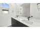 Bright bathroom featuring double sinks, black fixtures, and modern finishes at 2004 Peaceful Mesa Ct, Henderson, NV 89052