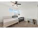 Neutral bedroom includes two beds, a fan, and a view to the outside at 2004 Peaceful Mesa Ct, Henderson, NV 89052