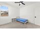 Bright bedroom with ceiling fan, large window showcasing neighborhood view, and small bed at 2004 Peaceful Mesa Ct, Henderson, NV 89052