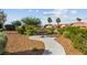 A community park featuring a picnic table surrounded by lush landscaping and a winding pathway, perfect for outdoor gatherings at 2004 Peaceful Mesa Ct, Henderson, NV 89052