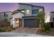 Modern two-story home with a two-car garage, desert landscaping, and a brick driveway at 2004 Peaceful Mesa Ct, Henderson, NV 89052