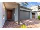 Home exterior showcases a well-maintained front entrance, a garage, and tasteful landscaping at 2004 Peaceful Mesa Ct, Henderson, NV 89052