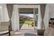Bright living room view of backyard; featuring sliding glass doors, artificial grass, and a privacy wall at 2004 Peaceful Mesa Ct, Henderson, NV 89052