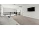 Spacious loft area with carpeted floors, a large TV, and an open railing overlooking the lower level at 2004 Peaceful Mesa Ct, Henderson, NV 89052