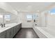 Bright main bathroom features double sinks, soaking tub, and walk-in shower at 2004 Peaceful Mesa Ct, Henderson, NV 89052