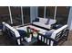 A covered patio features modern outdoor furniture around a central fire pit and overhead lighting at 2004 Peaceful Mesa Ct, Henderson, NV 89052