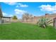 A large backyard with well-maintained lawn and desert landscaping at 2058 Citroen St, Las Vegas, NV 89142