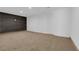 Spacious basement featuring carpet flooring, dark accent wall, and bright white walls at 2058 Citroen St, Las Vegas, NV 89142