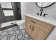 Updated bathroom features modern vanity, sleek fixtures, and walk-in shower with decorative tile and flooring at 2058 Citroen St, Las Vegas, NV 89142