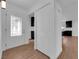 Inviting entryway with decorative glass door, wood-look floors, and closet, leading to an updated kitchen at 2058 Citroen St, Las Vegas, NV 89142