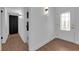 Bright hallway with wood-look flooring, leading to stylish bathroom and front door with decorative glass at 2058 Citroen St, Las Vegas, NV 89142