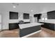Bright kitchen featuring a center island, modern appliances, dark cabinetry, and stylish finishes at 2058 Citroen St, Las Vegas, NV 89142