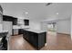 Modern kitchen with stainless steel appliances, island, and sleek dark cabinetry at 2058 Citroen St, Las Vegas, NV 89142