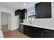 Kitchen featuring dark cabinets, quartz countertops, and stainless steel dishwasher at 2058 Citroen St, Las Vegas, NV 89142