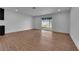 Spacious living room with wood-look flooring, and a glass slider that provides ample natural light at 2058 Citroen St, Las Vegas, NV 89142