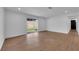 Open living room boasts wood-look flooring, large sliding glass door and access to other rooms at 2058 Citroen St, Las Vegas, NV 89142