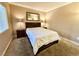 A bedroom featuring a large bed with a white comforter, two side tables, and a window at 210 E Flamingo Rd # 215, Las Vegas, NV 89169