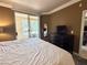 Comfortable bedroom with a sliding glass door to a balcony and a dresser with a TV on top at 210 E Flamingo Rd # 215, Las Vegas, NV 89169