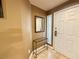Welcoming entryway with tiled floor, featuring a decorative mirror and a small accent table at 210 E Flamingo Rd # 215, Las Vegas, NV 89169